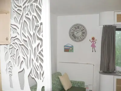 a living room with a clock on the wall at Liège centre 6 rue montagne sainte Walburge, 4000 Liège, pour 2 pers à 3 minutes de la gare st Lambert in Liège