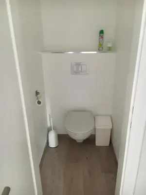 a small white bathroom with a toilet in it at Chalet M in Eupen