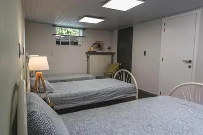 a hospital room with three beds and a window at Vakantiewoning & Fietslogies VELO, rustig vlakbij Maastricht in Bilzen