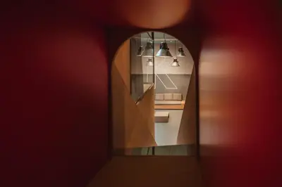 a hallway with a mirror and a red wall at Kindadom - Maison pour vacances insolites et inoubliables en Belgique in Montzen