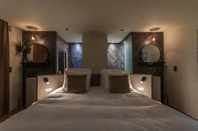 a bedroom with a large bed with two pillows at Bed & Breakfast Nummer5 in Heusden - Zolder