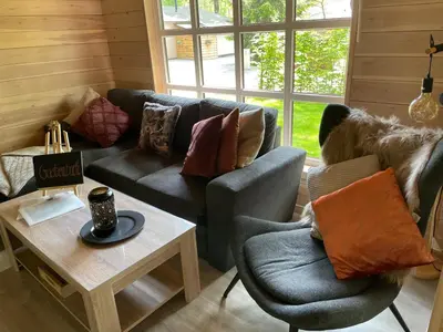 a living room with a couch and two chairs at Chalet Sint-Hubertus Deluxe in Zutendaal