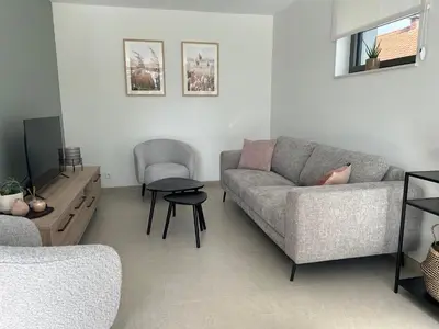 a living room with a couch and a table at Vakantiewoning Laurijn in Bilzen