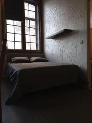 a bedroom with a bed and a window at Studio donceel in Liège