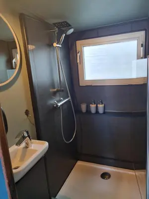 a bathroom with a shower and a sink at La Cabine du Capitaine in Liège