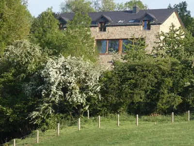a brick house with a fence in front of it at Un air de bourlingueurs in Pepinster