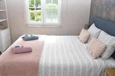 a bedroom with a bed with two pillows on it at B&b La Villa Orchidées, breakfast included in Bassenge