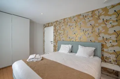 a bedroom with a bed with a floral wallpaper at Au bois du Sart-Tilman in Sur le Mont