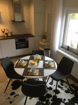 a kitchen with a table and chairs in a room at Villa van Brienen - Studio in Dilsen-Stokkem