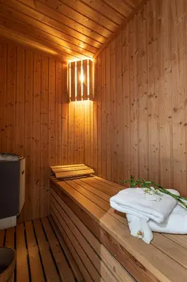 a wooden sauna with a white towel on thevisor at Maison Noppius - Love Hotel in Liège