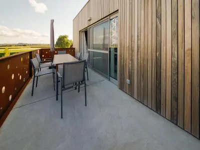 a balcony with a table and chairs on it at Holiday home in Vise Richelle near town in Richelle