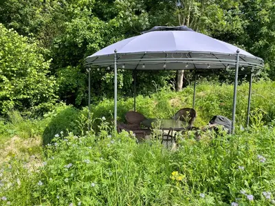 an umbrella sitting in the middle of a field at Bellerose Maison de Greunebennet in Plombières