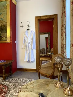 a white suit hanging on a wall in a room at Gite de Caractère Le Lys Bleu in Limbourg