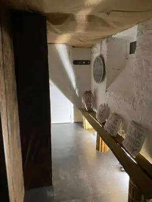 a room with a row of benches in a building at Le Retour aux Sources - Chambre d'Hôte chaleureuse et conviviale in Chaudfontaine
