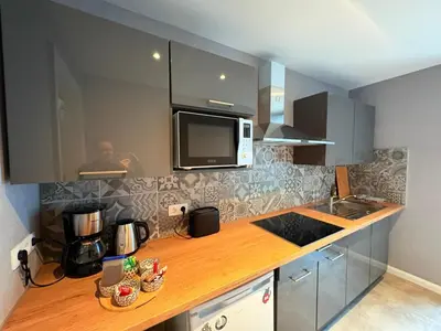 a kitchen with a counter top with a microwave at Le Piercot in Liège