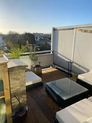a balcony with two beds on a roof at Gezellig 1 slaapkamer appartement nabij het stadscentrum in Hasselt