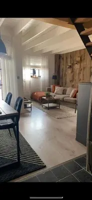 a living room with a couch and a table at Maas Lodge in Maaseik