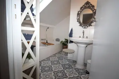 a bathroom with a sink and a bath tub at B&B Le Jardin in Pelt