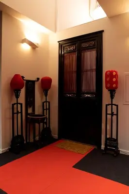 a room with a red carpet and a black door at Wabi Sabi B&B in Peer