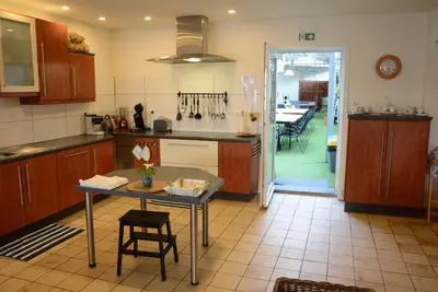 a kitchen with a table and a dining room at Vakantiewoning Het Wielje Maasland in Kinrooi