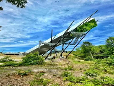 a sculpture of a plane sitting on top of a field at De Appelgaard Voeren Estate in Berg