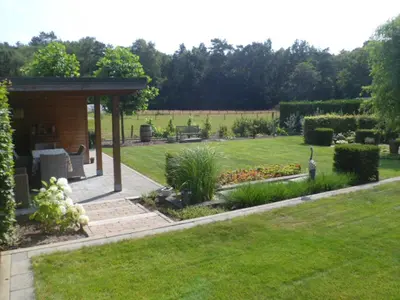 a garden with a pavilion in the middle of a lawn at Bosrand81 in Hechtel