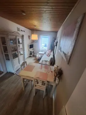 a living room with a table and a couch at ländlich & gemütlich in Raeren mit 2 Schlafzimmern in Raeren
