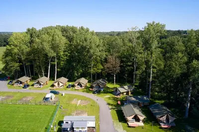 an aerial view of a campground with a road and trees at Glamping Belgisch Limburg in Oudsbergen