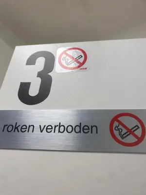 a sign on a wall with several signs on it at Nummer 151 villastudios in Hasselt