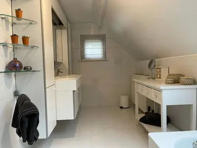 a white bathroom with a sink and a mirror at Sterrenheide in Heusden - Zolder