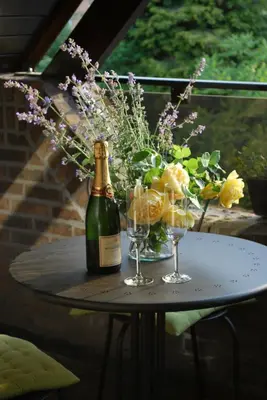 a table with a bottle of champagne and two wine glasses at Pieters Huis in Kinrooi