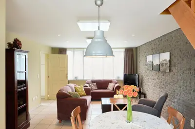 a living room with a couch and a table at Pieters Huis in Kinrooi