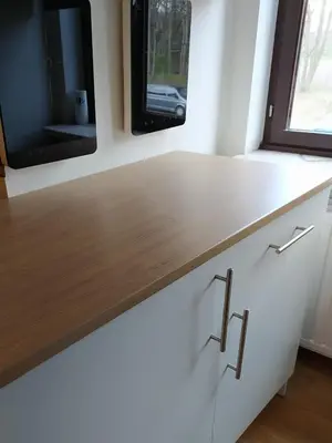 a kitchen with a wooden counter and a tv on the wall at Wonderwall in Houthalen-Helchteren