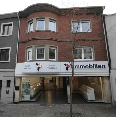 a building with a sign for a museum at Appart Nicolas in Eupen