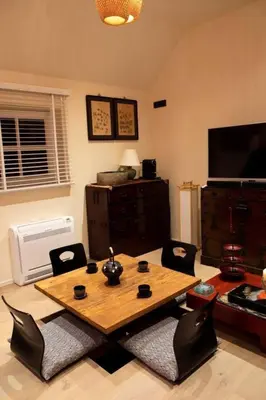 a living room with a wooden table and chairs at 1 Bed Villa - Sleeps 2 - Garden - Parking - Wifi in Grote-Brogel