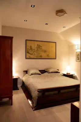 a bedroom with a bed with two night stands and two lamps at 1 Bed Villa - Sleeps 2 - Garden - Parking - Wifi in Grote-Brogel
