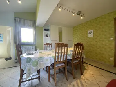 a dining room with a table and four chairs at Drieskenshoeve in Grote-Brogel