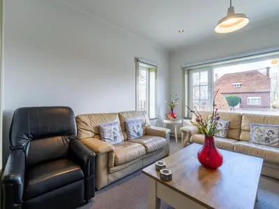 a living room with a couch and a table at Secretarishuis in Peer