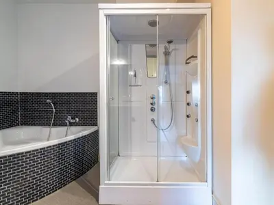 a bathroom with a shower and a tub and a sink at Secretarishuis in Peer