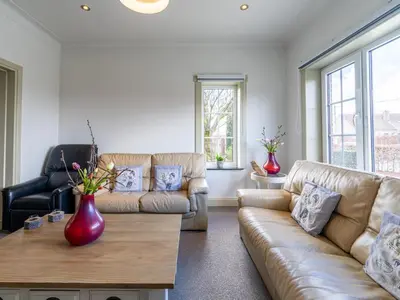 a living room with two couches and a coffee table at Secretarishuis in Peer