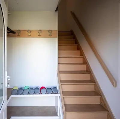 a staircase with wooden treads in a house at Holiday Home Op 't Busselen in Opoeteren
