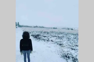 a woman walking down a path in the snow at Duplex 90m Centre Verviers Calme Gare à pied Spa Francorchamps 20 min in Verviers