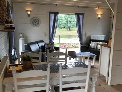 a living room with a table and chairs and a couch at Viva La Vie in Maaseik