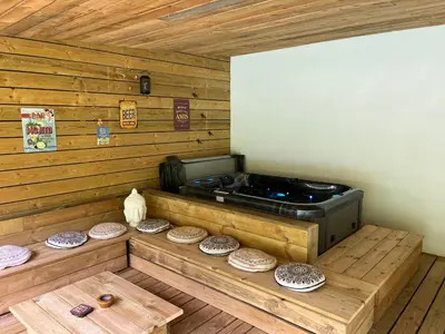 a stove in a room with wooden walls and wooden floors at Paradis Secret in Beyne-Heusay