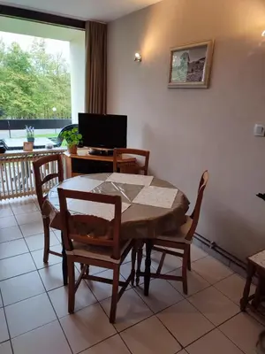 a dining room with a table and chairs and a television at Your Stay in Kelmis - La Calamine- Cosy apartment in the Ardennes -Three-country point - Neu-Moresnet in Kelmis
