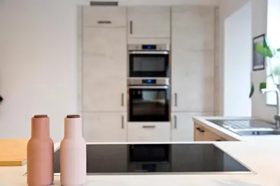 a kitchen with two vases sitting on a counter at Vakantiewoning Spoor 23 in Borgloon
