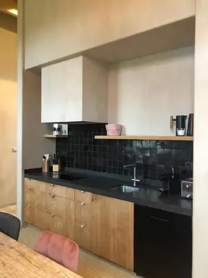 a kitchen with a sink and a black counter top at Factorij10 in Peer