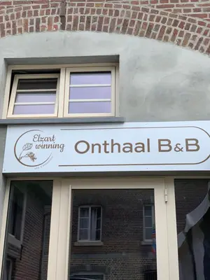 a sign for anental bd on a brick building at B&B elzartwinning in Hasselt