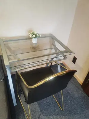 a glass table with a plant on top of a chair at Ferienwohnung in einem alten Bauernhaus in Lontzen