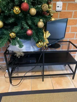 a laptop sitting on a glass table next to a christmas tree at La Casita E41 in Lanaken